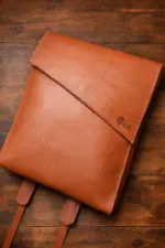 Tan leather backpack on a table