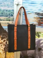 Black leather tote with brown straps for work or travel