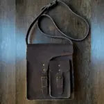 leather sling bag laid on a table