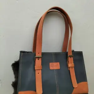 Rani mini leather tote in Navy and chestnut straps