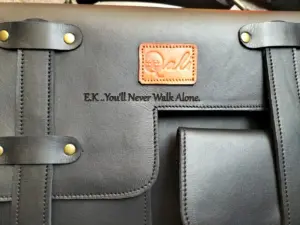 Custom message engraved on a black Qali leather bag